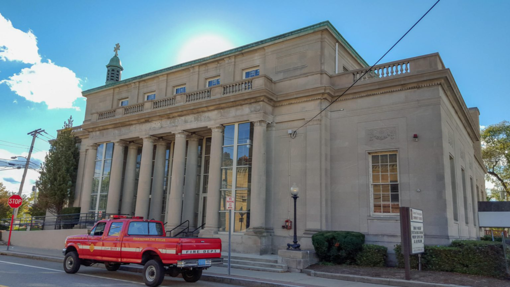 A commercial building in Boston with a red truck parked outside
