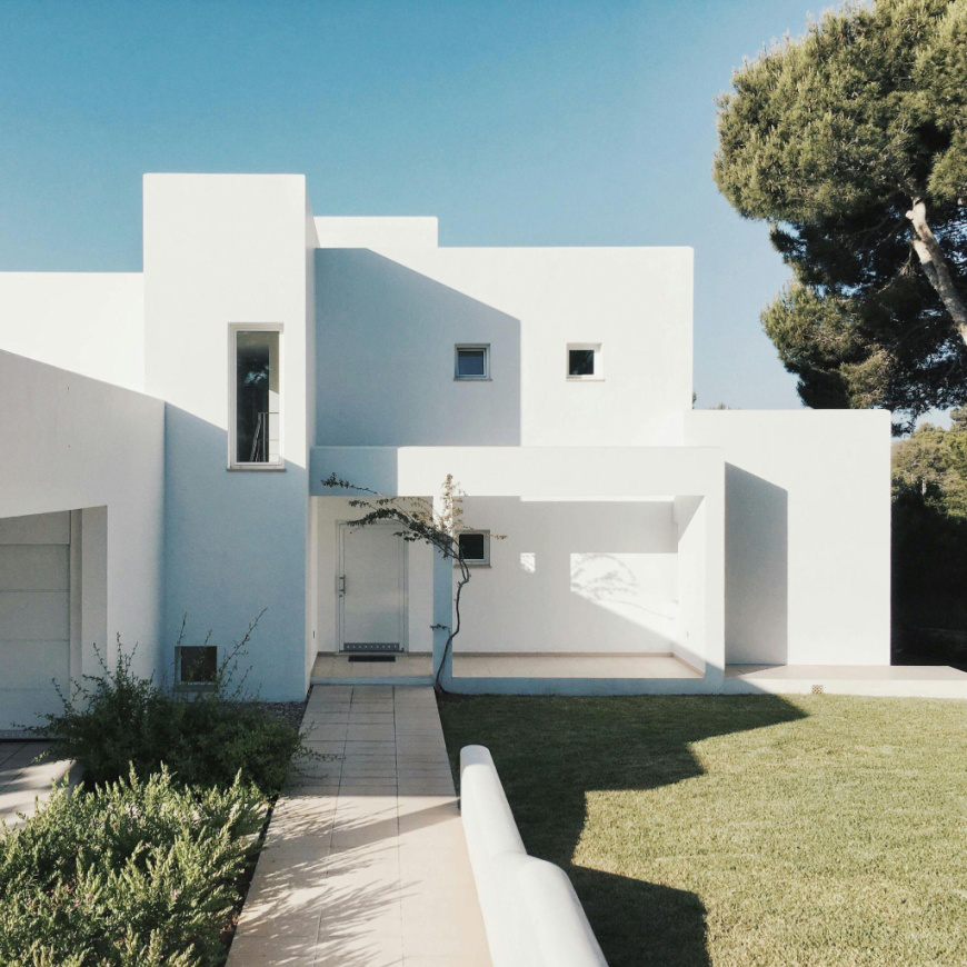 A white 2-story concrete house.