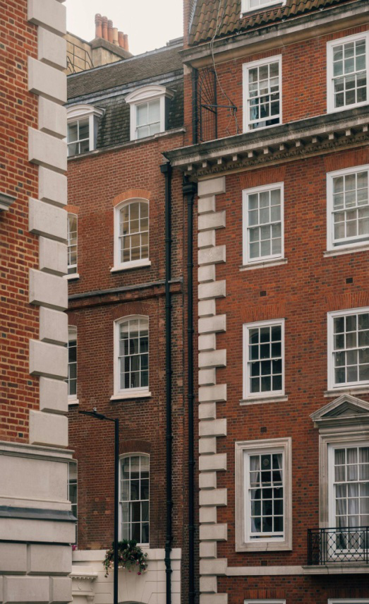 An old red brick building with white windows