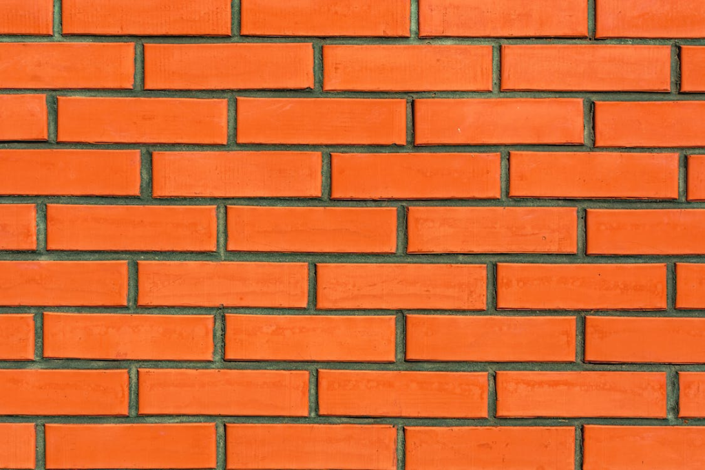 a bright orange colored brick wall