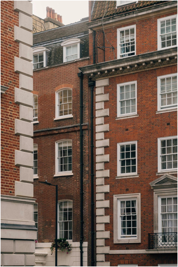 Classic red brick apartment building with white-framed sash windows
