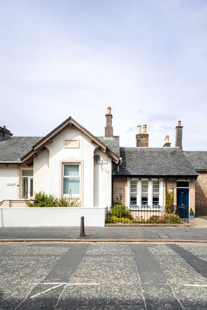 A photo showing a property with grey chimneys