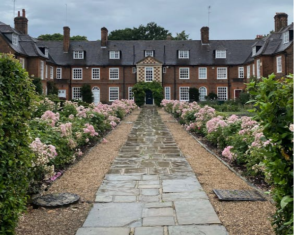 A well-maintained garden pathway lined with pink flow