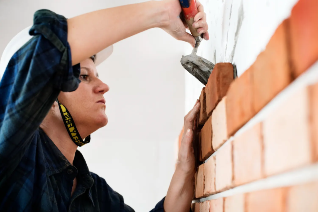 Brick repointing contractor Boston repairing damaged mortar joints on residential brick wall