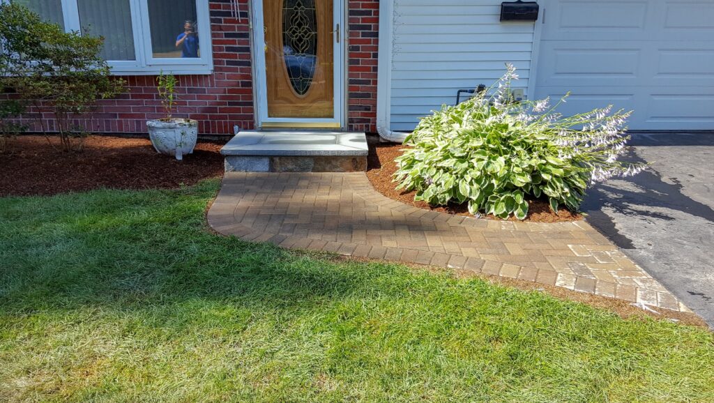 Brick paver walkway and front entry steps of a home