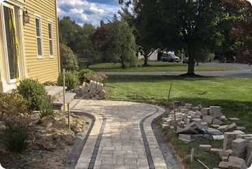 Restored paver walkway leading to a residential home with improved appearance, safety, and curb appeal.