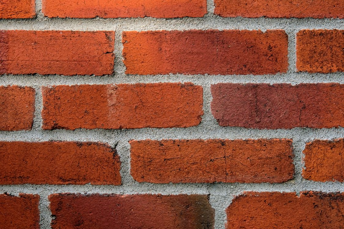 Close-up of a brick wall with well-maintained mortar joints demonstrating the importance of repointing for masonry durability.