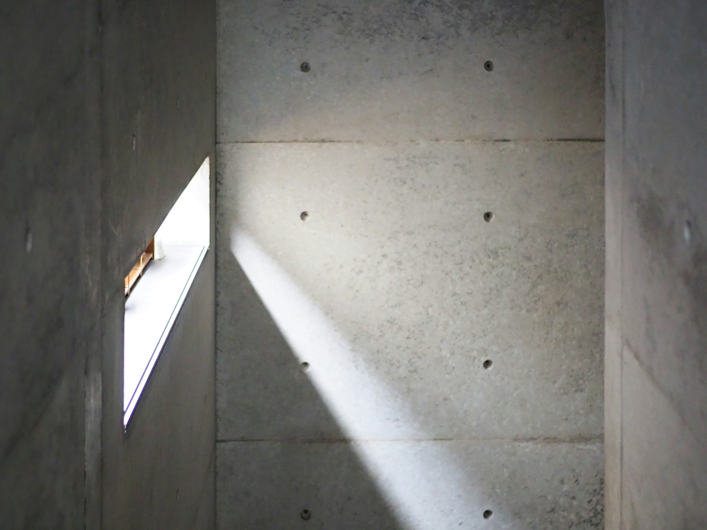 Concrete basement foundation wall with natural light highlighting a dry and protected interior space.